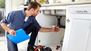 Middleboro homeowner inspecting water leak under his sink