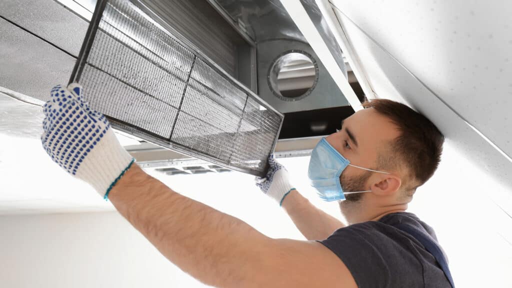 Heating Services and Boiler repair technician performing an air duct cleaning