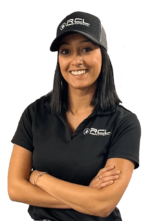 A woman wearing a black RCL Mechanical polo shirt and matching black cap, smiling with her arms crossed
